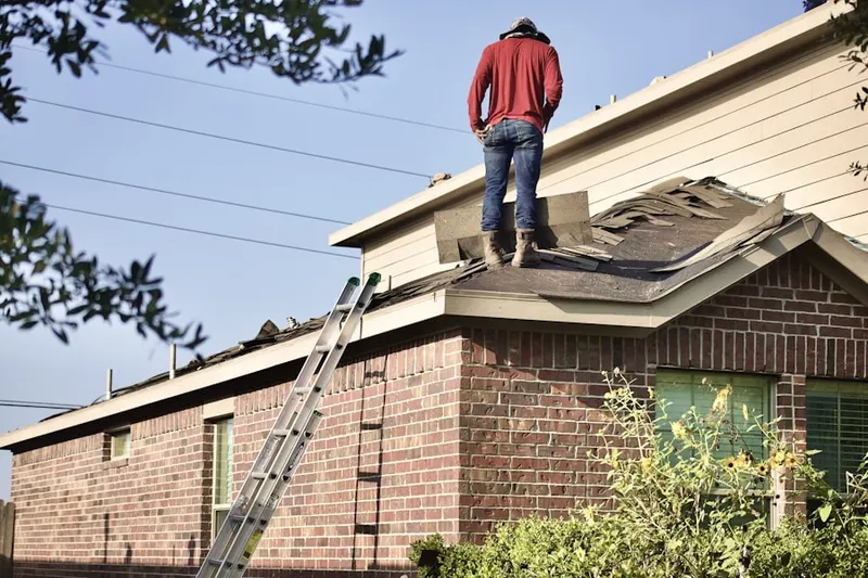 Professional roofer working on a residential roof in Middle Island